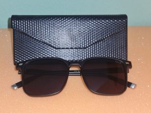 Black sunglasses and case. 