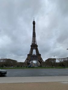 A perspective view of the Eiffel tower in Paris on a cloudy day.
