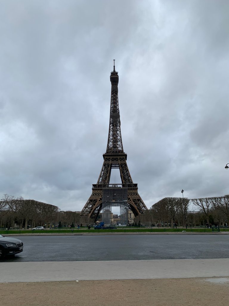 A perspective view of the Eiffel tower in Paris on a cloudy day.