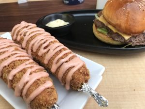 Cheese corn-dog and burger.  