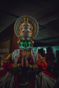 Kathakali performance unfolds in vivid colors, showcasing the artistry of traditional Indian dance with elaborate costumes and expressive gestures, capturing the essence of cultural storytelling.