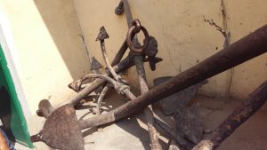 Ancient rusty boat anchors once used in the old kingdoms of Varanasi, now preserved in museums as relics of a bygone era.