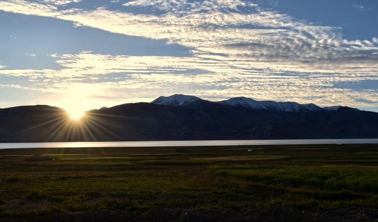 Sunrise over a mountain under a cloudy sky in Tsomo riri