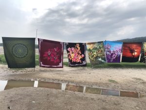 Large printed, colorful cloths hang on a clothesline