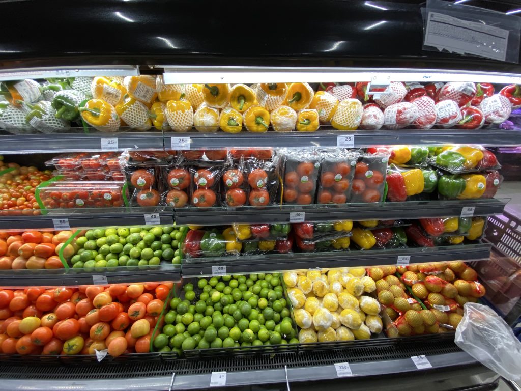 A display in a grocery store filled with lots of fruits and vegetables