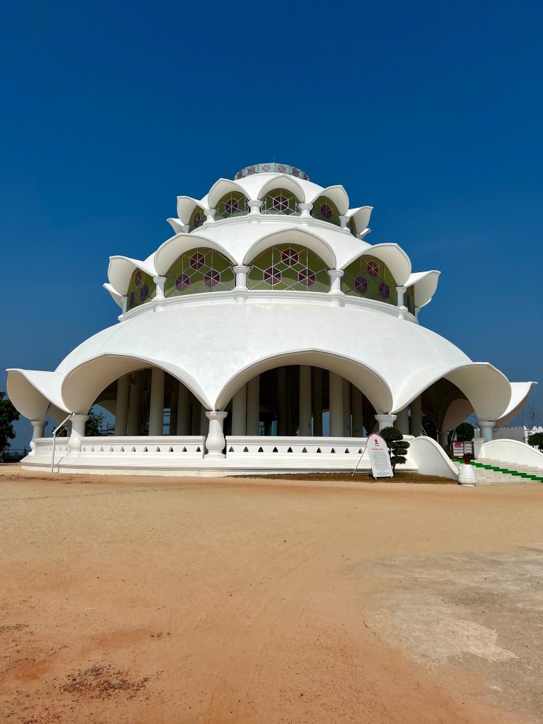 Santhigiri Ashram, a white building against a dark blue sky