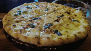 Pizza ai quattro formaggi is a variety of pizza in Italian cuisine that is topped with a combination of four kinds of cheese.