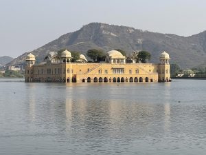 The Water Palace stands as a masterpiece of architectural harmony, with its golden walls and domes mirroring the tranquility of the surrounding waters and hills.
