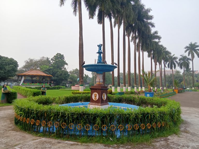 A fountain and trees in Eden Gardens Park in Kolkata, West Bengal, India.