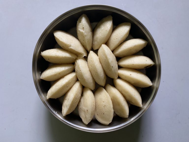 A steel container filled with Idali (South-Indian dish)