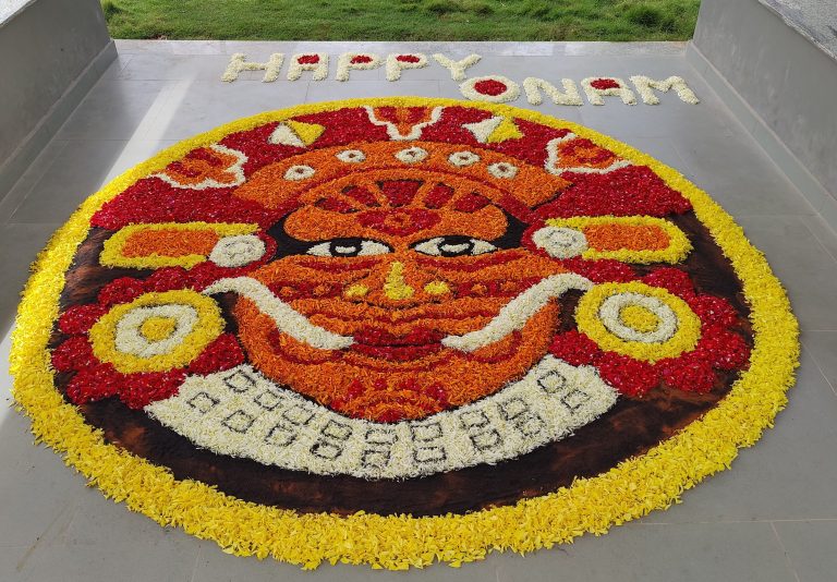 Pookalam a colourful arrangement of flowers laid on the floor with the design of Theyyam (famous ritual art form that originated in North Kerala).