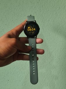 A smartwatch with a green-colored strap.