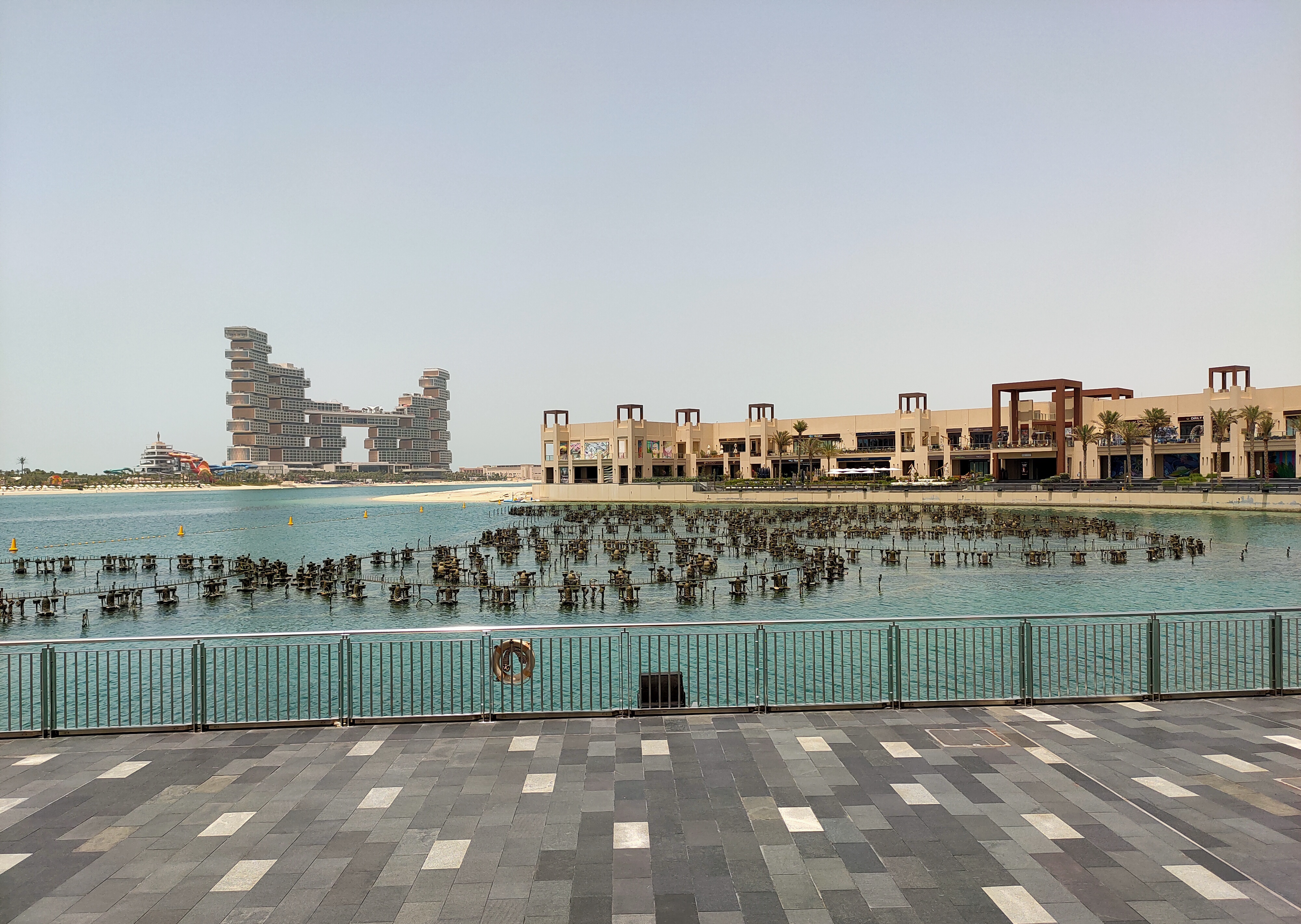 A stunning shot of Atlantis, The Royal in Dubai, taken from the beachside restaurant known as The Point, capturing the beauty of this iconic structure against the backdrop of the Arabian Gulf.