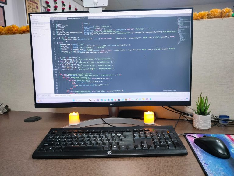 Web development: Code on screen, candles, home plant—a cozy and productive workspace ambiance.