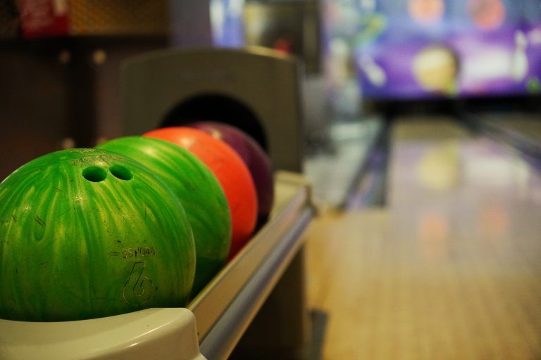 Colorful bowling balls in a bowling alley.