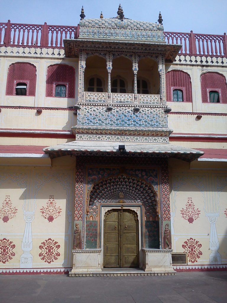 A stunning photo captures the intricate carvings of a ‘mayur door,’ featuring a peacock motif, in the City Palace of Jaipur.