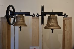 Church bells held on wooden posts
