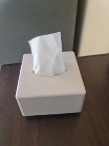 View larger photo: A white pop-up napkin dispenser with napkins.