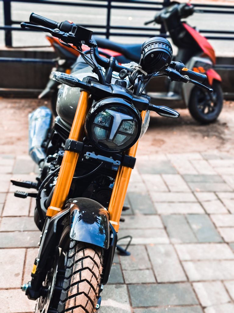 Black and orange motorcycle from the front.