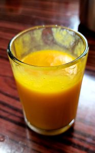 Mango juice in a crystal glass.