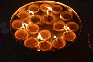 A platter brimming with oil lamps, during the Diwali evening.