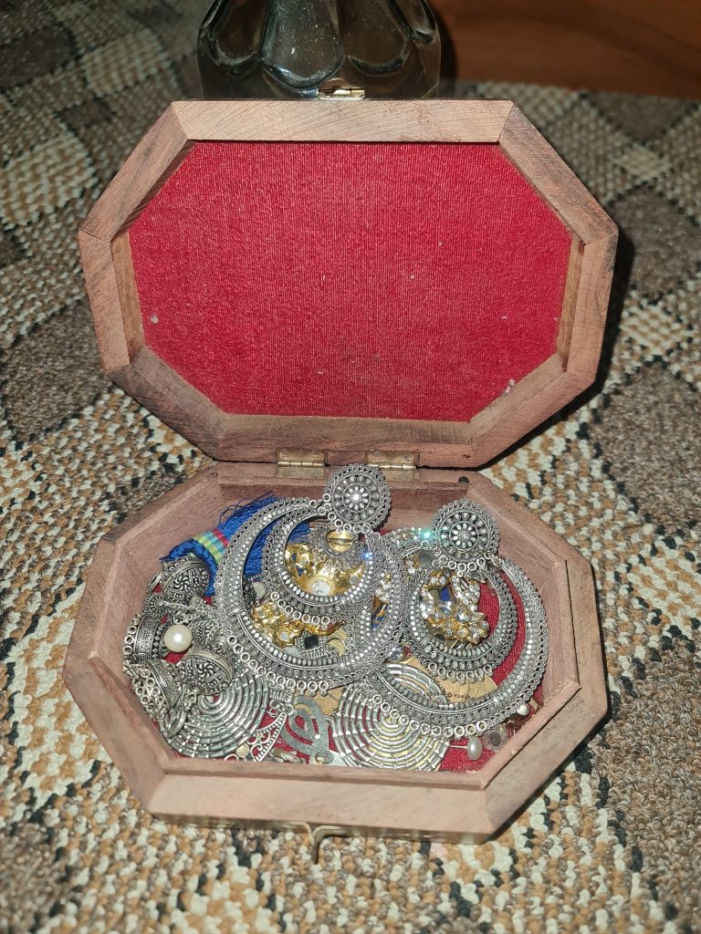 Assortment of silver jewelry stored in a jewelry box.