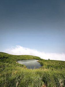 View larger photo: Chembra peak Wayanad (pond) on a hill with a dark sky overhead