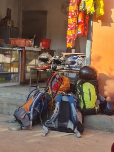 Four backpacks are packed and prepared for a trekking adventure. 