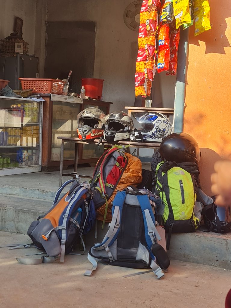 Four backpacks are packed and prepared for a trekking adventure.