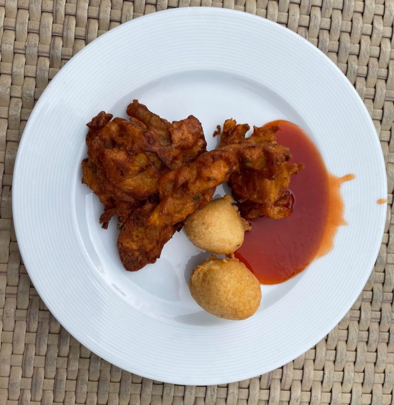 Crispy uzhunnu vada and flavorful onion vada served on a white plate, perfect companions for a cozy evening snack.