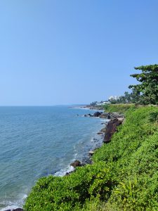 Sea view from standing on the side of a road.