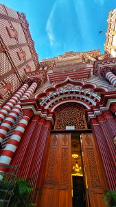 Gate 4 of the Jami Ul-Alfar mosque in Colombo, Sri Lanka. The style of architecture draws from a revivalist architectural style combining traditional Indo-Islamic architecture with more gothic with a red and white pattern (pomegranate) and new classical styles popular in the West.

