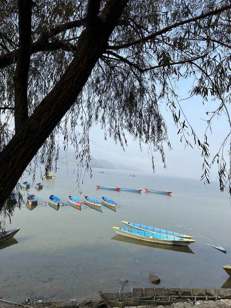 Beautiful view of a lake with boats docked on the shore, Fewa Lake, Pokhara