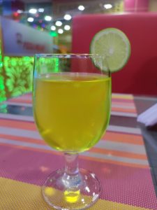 View larger photo: A glass of soft drinks with a lemon slice on the edge.