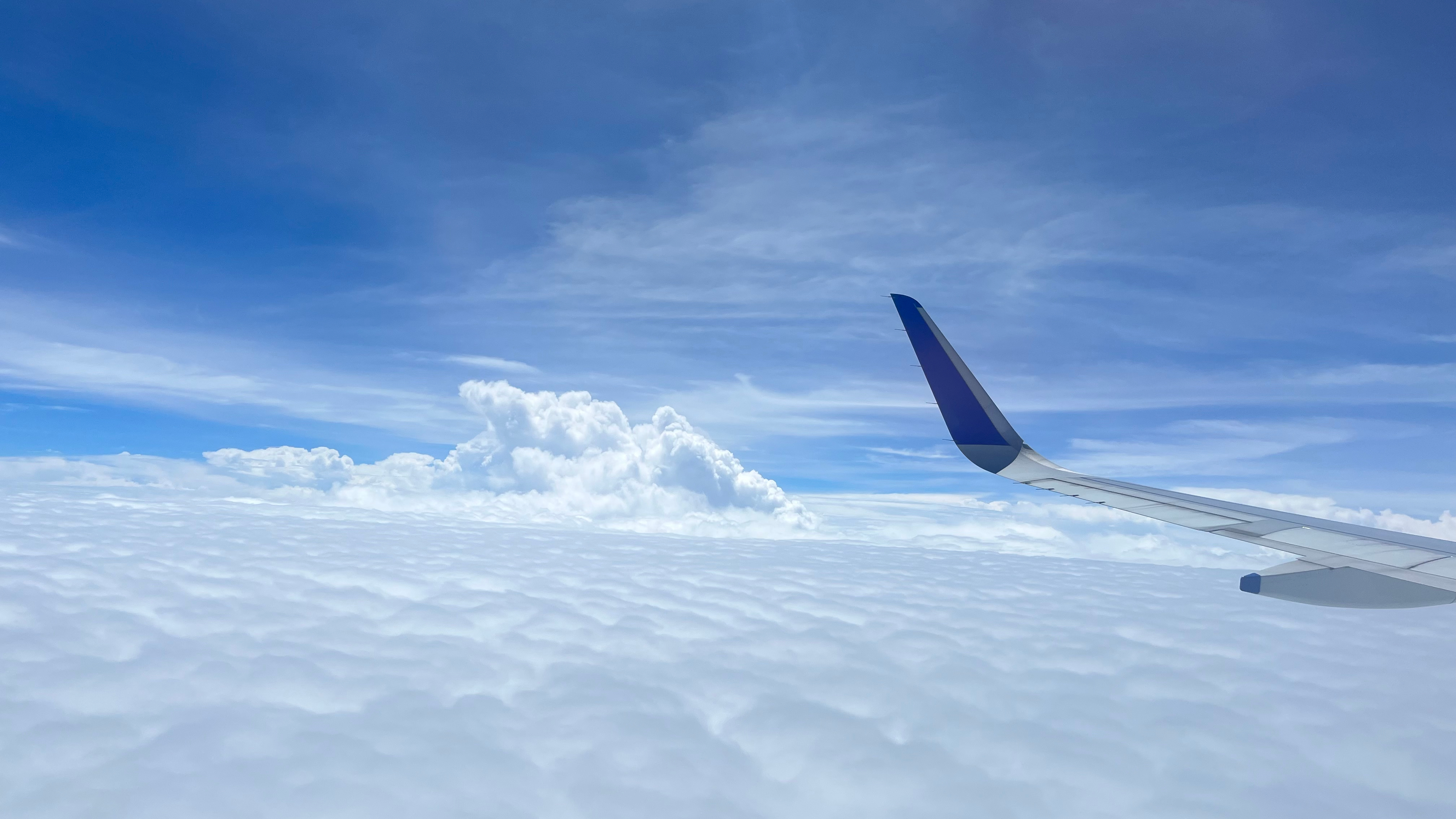 Wing of an airplane flying above the clouds