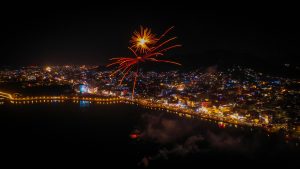 View larger photo: Fireworks over a city by the water