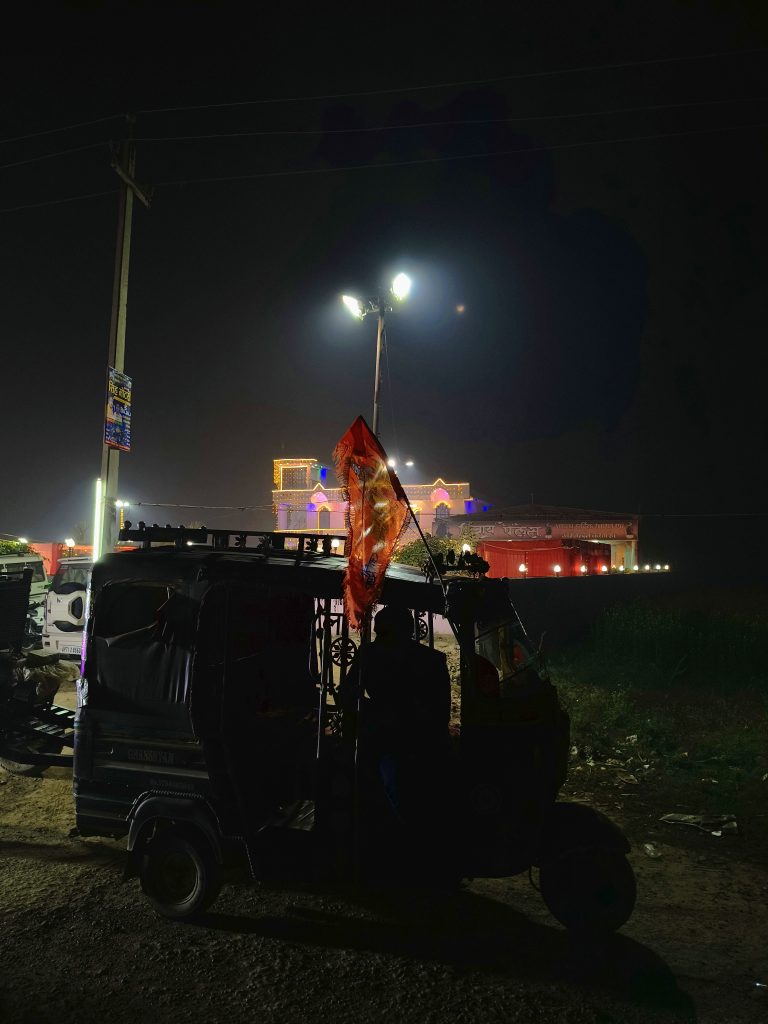 A Tuktuk, a local auto rickshaw, standing in the street at night.