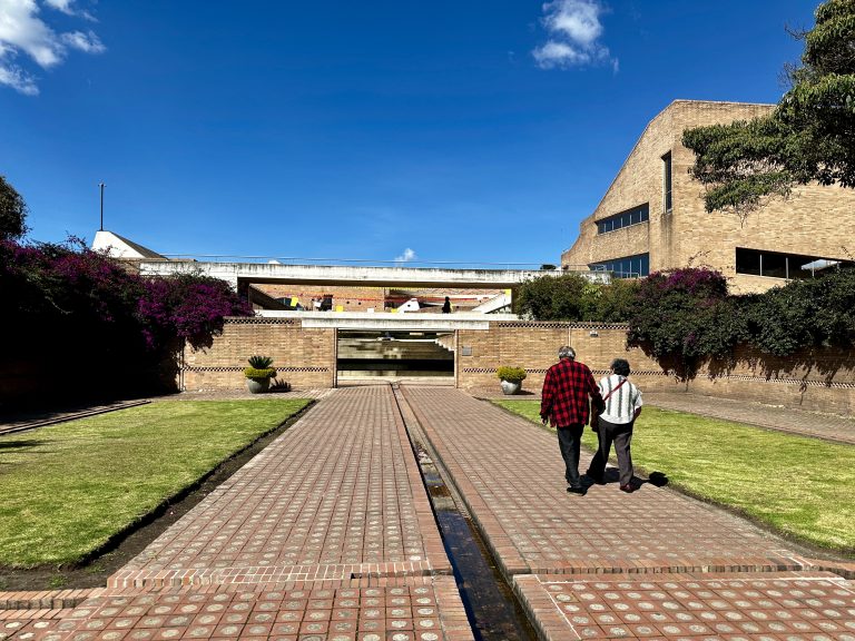 An elderly couple entering the Virgilio Barco Library designed with exposed brick by renowned architect Rogelio Salmona in Bogotá, Colombia.