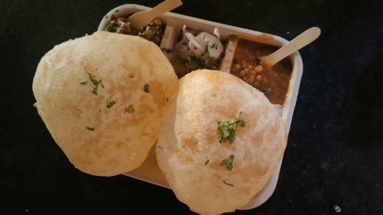 Chhola Bhatura, also known as Chole Bhature. An Indian north Indian traditional cuisine, combination of spicy white chickpeas and  deep-fried bread made from refined wheat flour