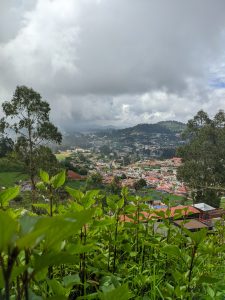 Distant view of the township in a valley with clouds above.