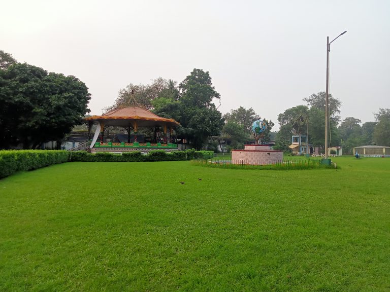 Green lawns and a hut, Eden Gardens Park in Kolkata, West Bengal, India.