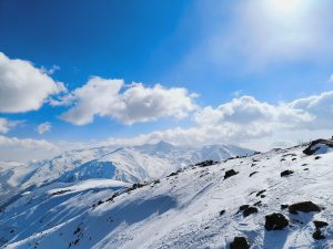 Snowy peaks under sunny skies.