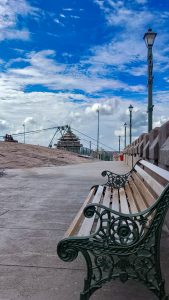 Atop Jatayu Earth's Center, a tranquil seating bench invites contemplation beneath the expansive sky, with the iconic Jatayu Kodanda Rama Temple gracing the background—a picturesque fusion of nature and spiritual allure.