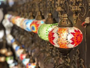 Multi coloured antique looking lights on display on a shop. 