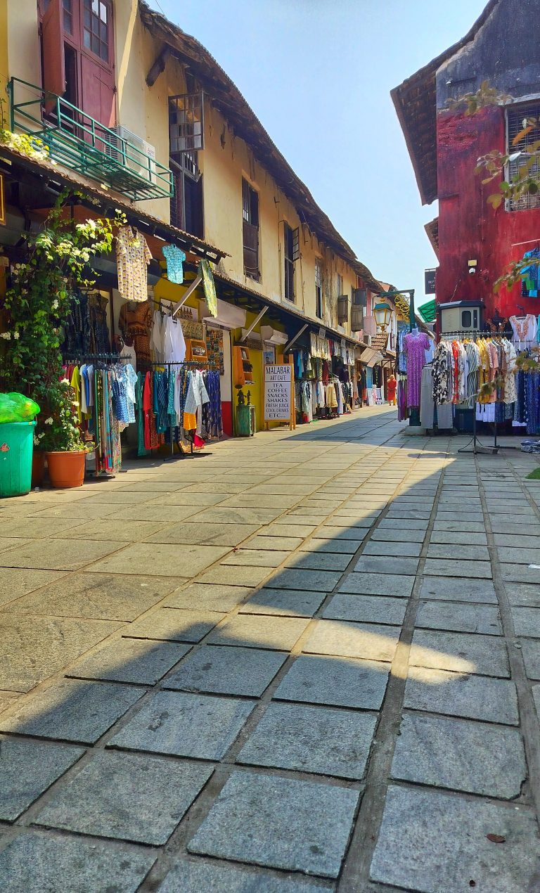 Strolling through the streets with colorful old buildings housing a variety of clothes shops and clear blue sky.