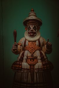 A dynamic Kathakali dance portraying the essence of Kerala's cultural heritage through vibrant costumes and expressive gestures. 