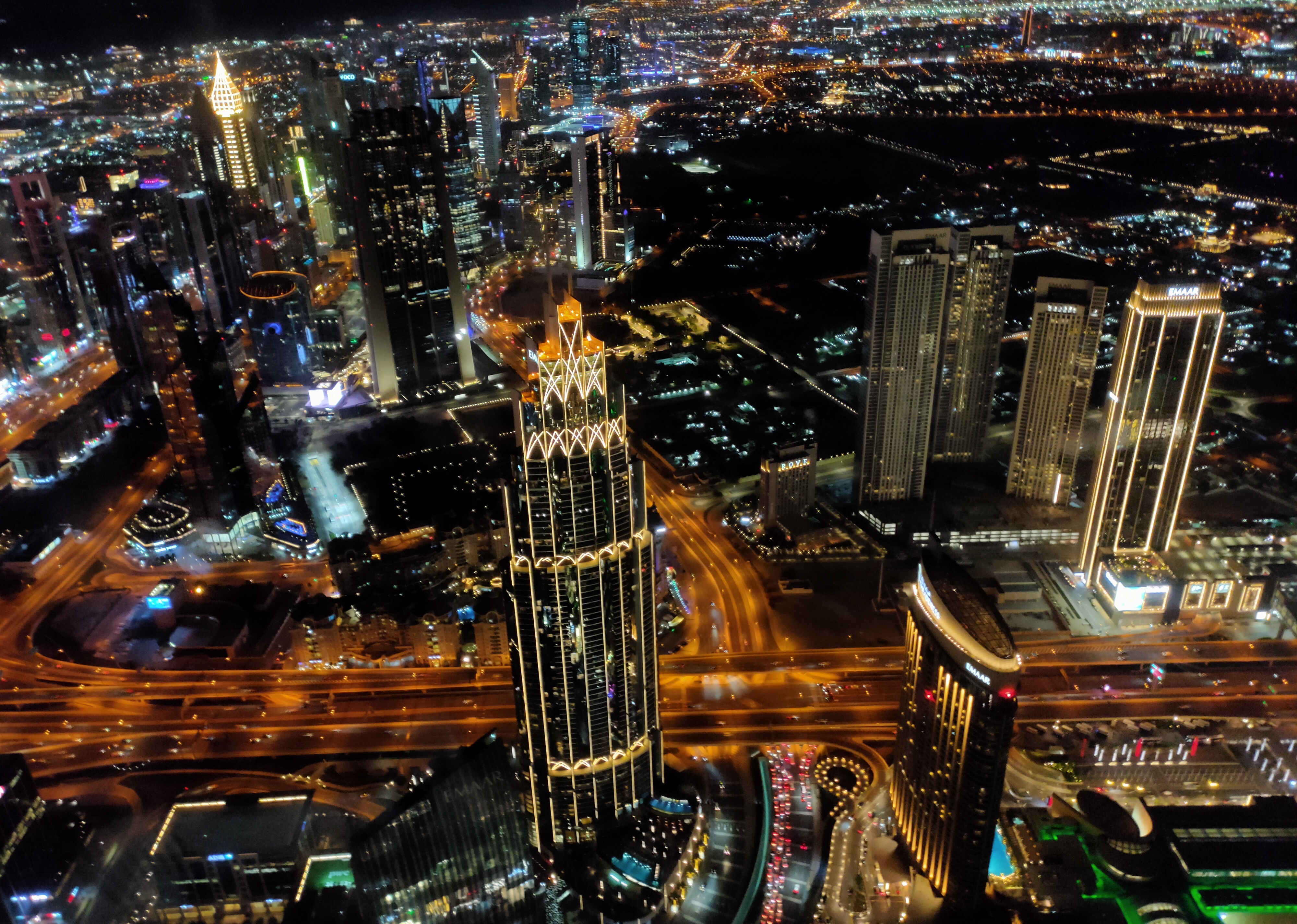 A captivating view from the 120th floor of Burj Khalifa, revealing the dazzling nightlife of Dubai, where city lights illuminate the urban landscape like a luminous tapestry.