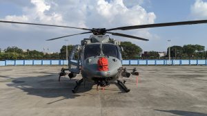 The image depicts an Indian Air Force helicopter, ALH Dhruv, parked on a concrete pad.