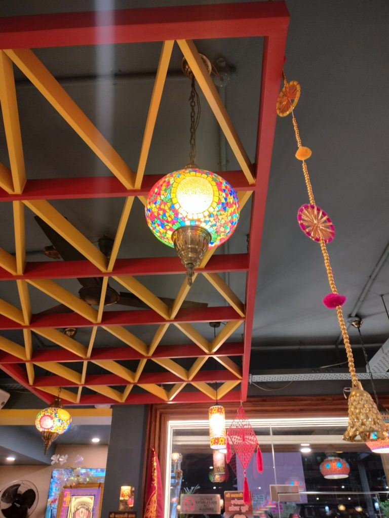 Mosaic lights hang from the ceiling in a cafe