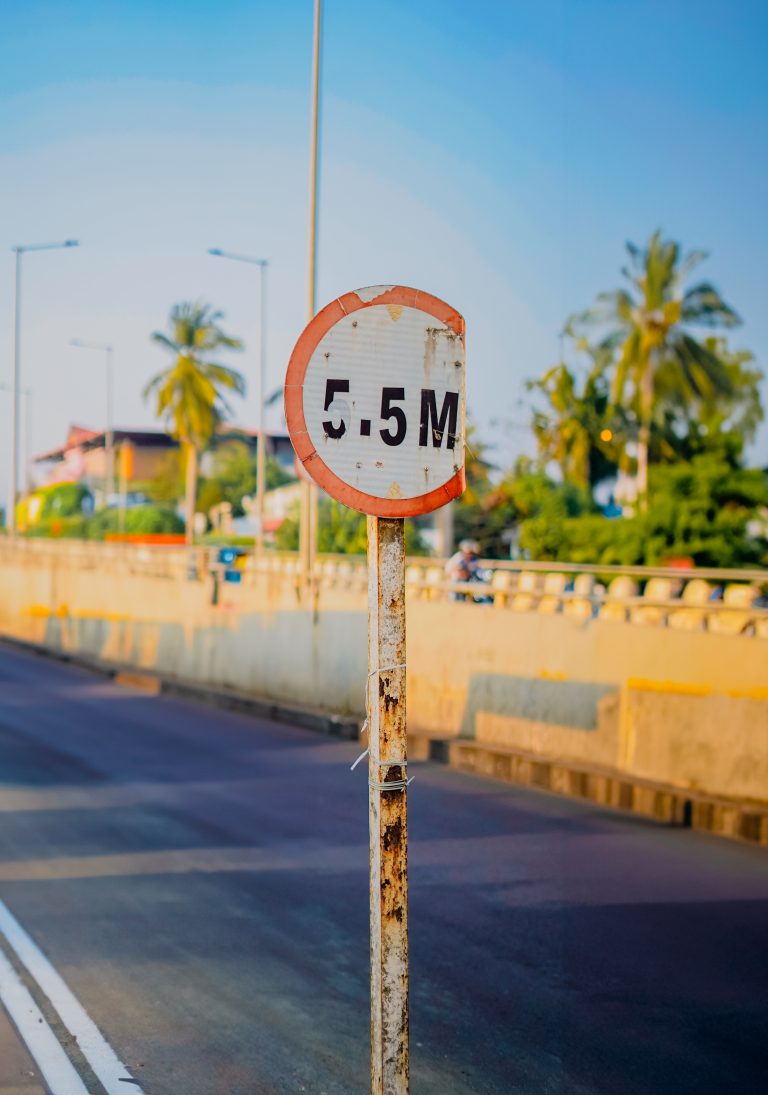 A partially damaged height indicator signal on the highway in Kerala.